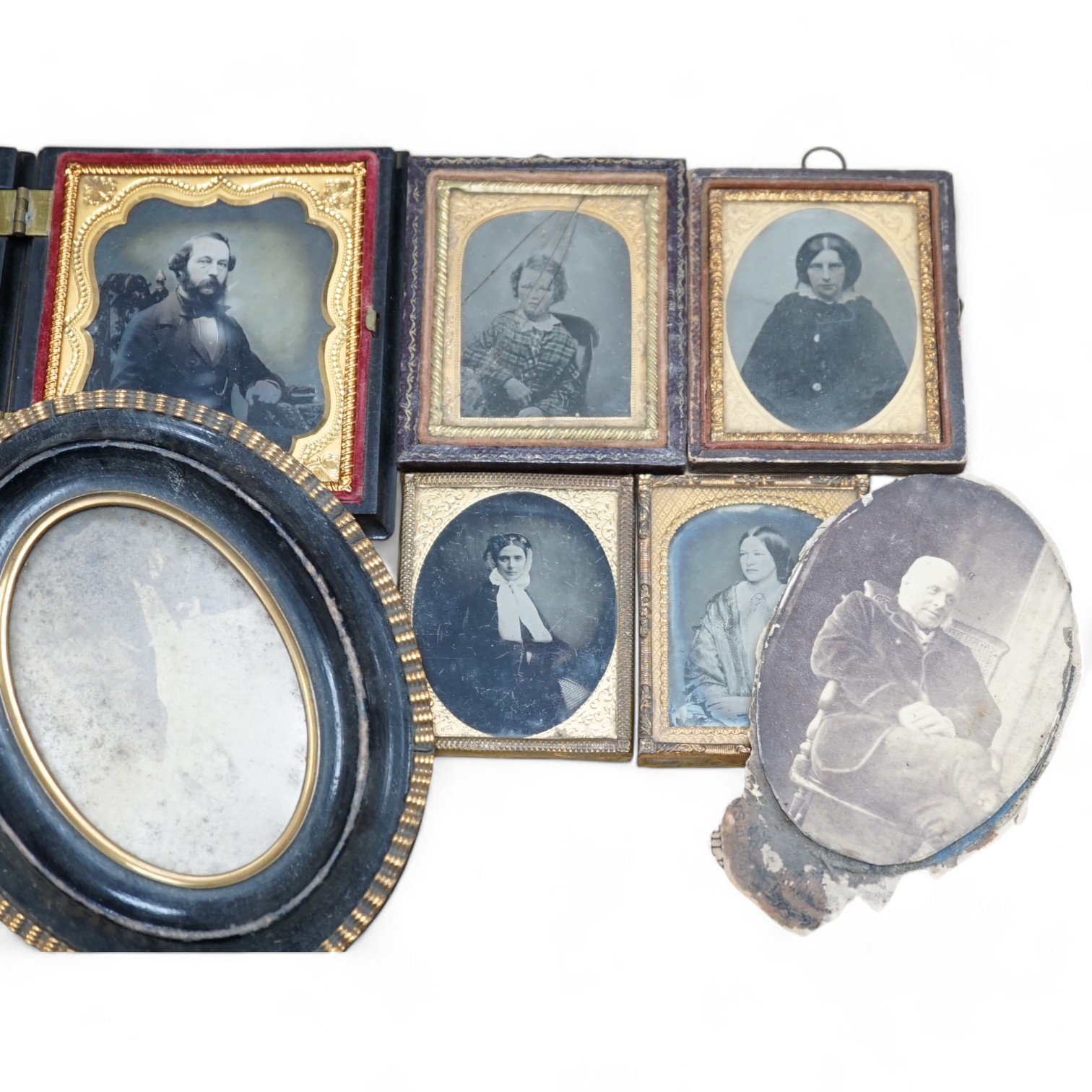 A collection of Victorian ambrotype and black and white photographs including two with original cases, largest 14cm high overall. Condition - poor to fair